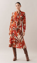 Mirabello luxurious pure silk neck tie V-neck long bishop cuff sleeve wrap bodice A-line midi dress in burnt orange, red, chestnut brown and camel floral print 
