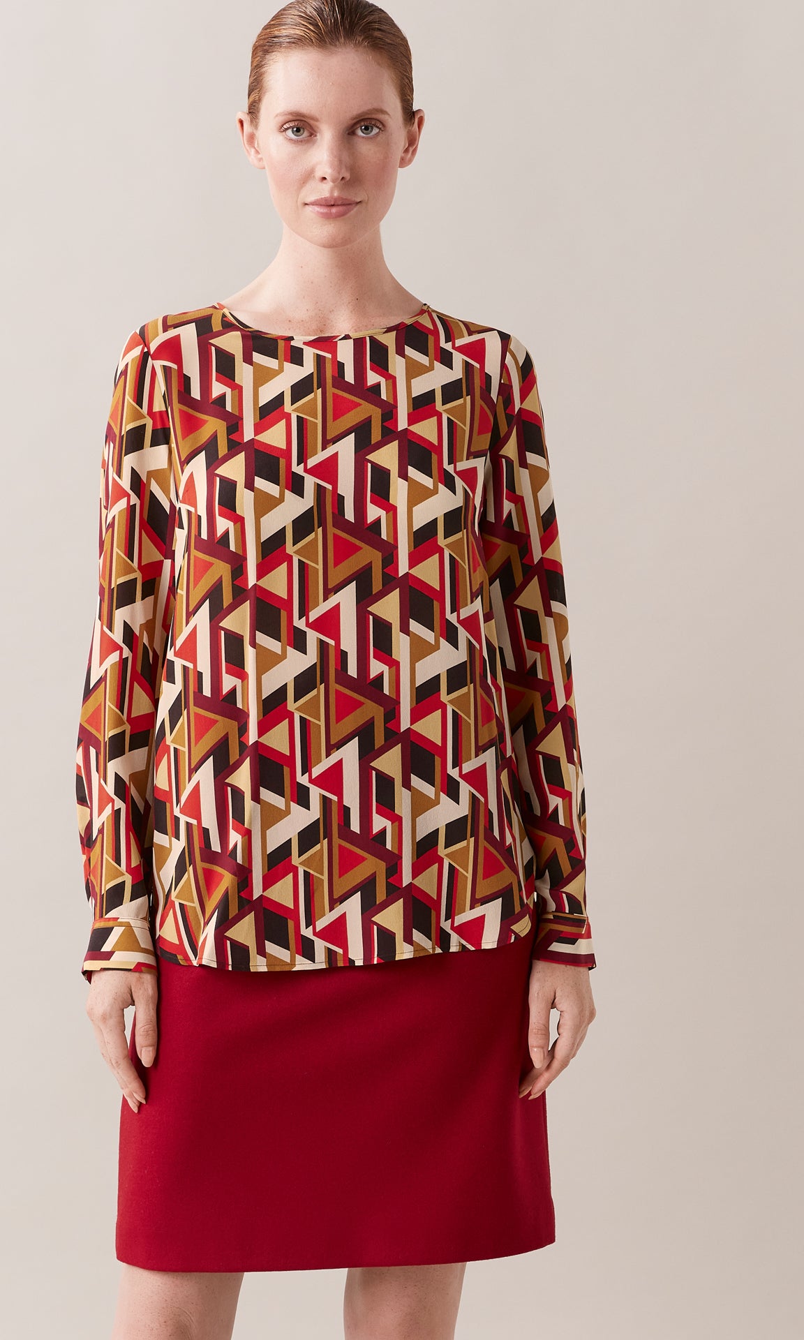 Adelma luxurious Italian silk crepe de chine crew neck gathered long cuff sleeve blouse in red, tan and mocha brown graphic geometric print