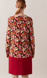 Adelma luxurious Italian silk crepe de chine crew neck gathered long cuff sleeve blouse in red, tan and mocha brown graphic geometric print