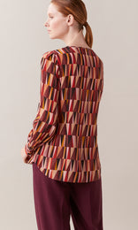 Pyramid Italian pure silk crepe de chine crew neck gathered long wide cuff sleeve blouse with neck keyhole opening in rhubarb red, berry, and peach orange geometric print design